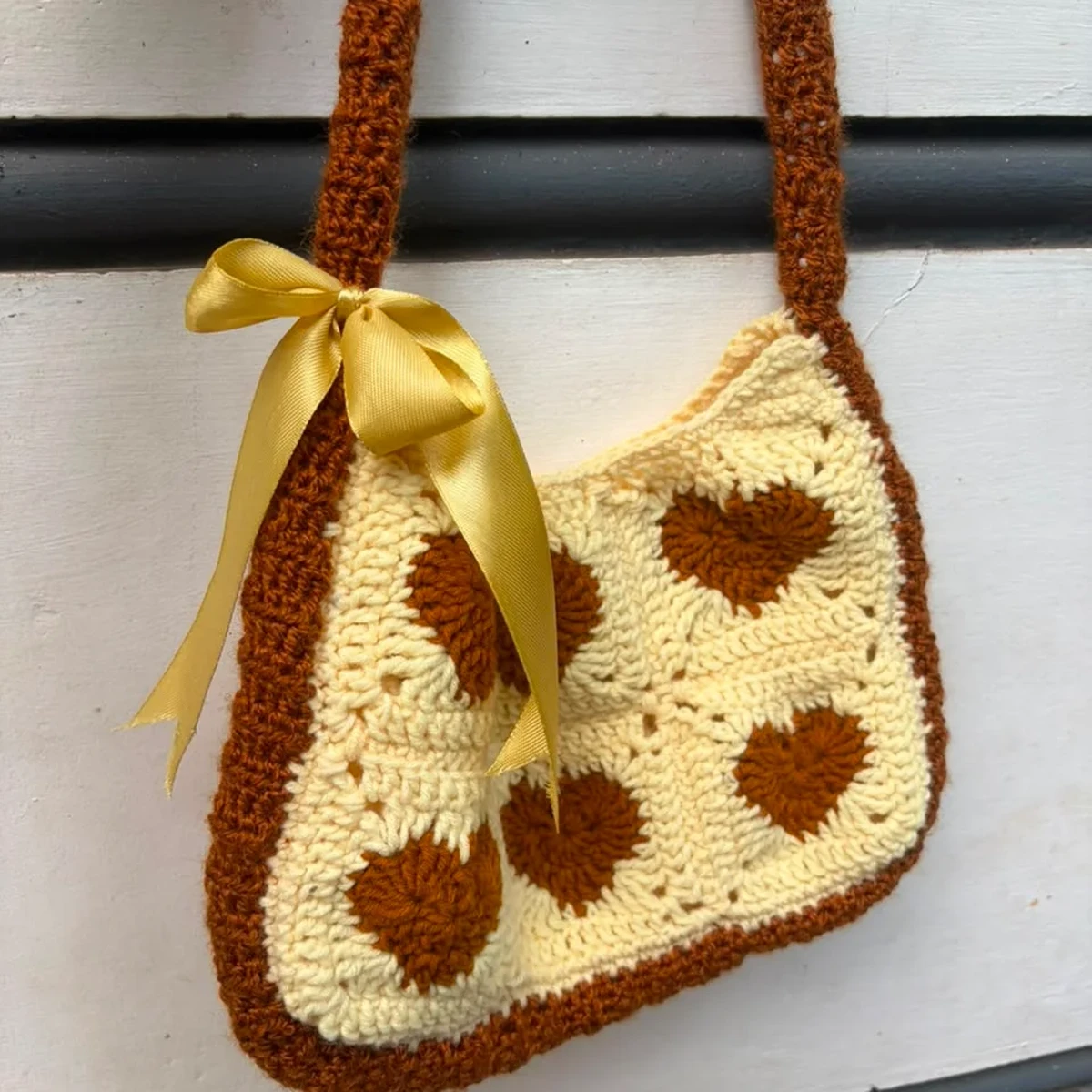 HOME Cream and brown crochet granny square bag with heart pattern and yellow ribbon