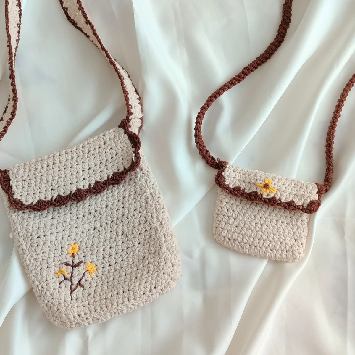 HOME Two beige crochet crossbody bags with embroidered flowers, one large and one small